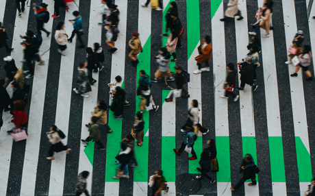 large crosswalk of people walking through