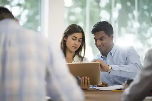 Employees Collaborating over laptop